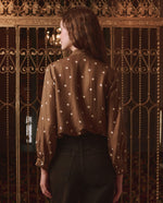 The Great Zenith Top Copper Bubble Dot tucked into brown baggy denim for cowgirl style