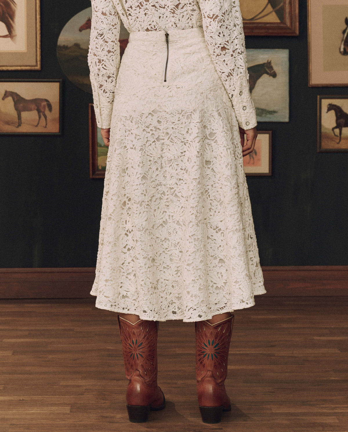 Stetson x THE GREAT Relic Lace Saddle Skirt styled with a tooled leather belt and cowboy boots cowgirl style