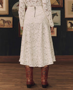 Stetson x THE GREAT Relic Lace Saddle Skirt styled with a tooled leather belt and cowboy boots cowgirl style