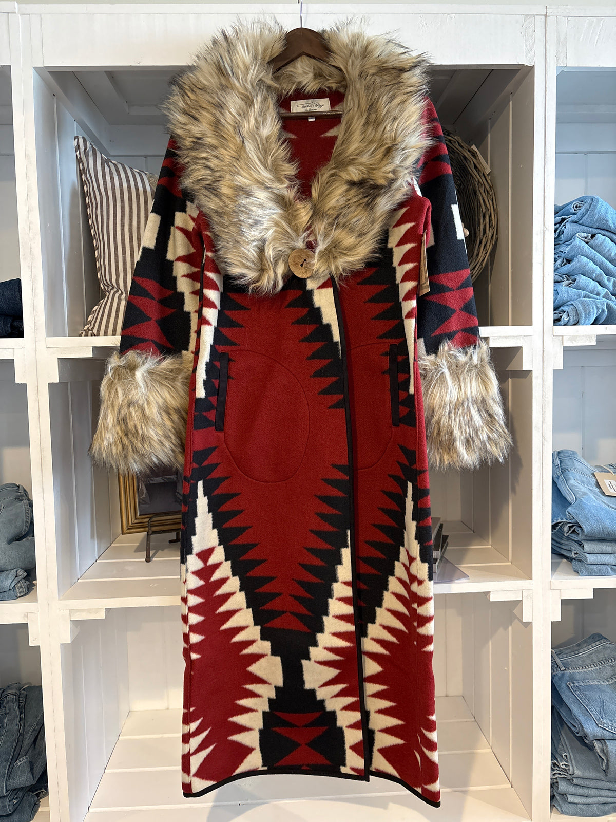 Tasha Polizzi Clay Coat Red Western clothing womens western boutique Utah  A long Southwestern-style coat with a red, black, and cream geometric pattern, featuring a large brown faux-fur collar and matching faux-fur trimmed cuffs in stock order today at bolt ranch store kamas utah near park city 