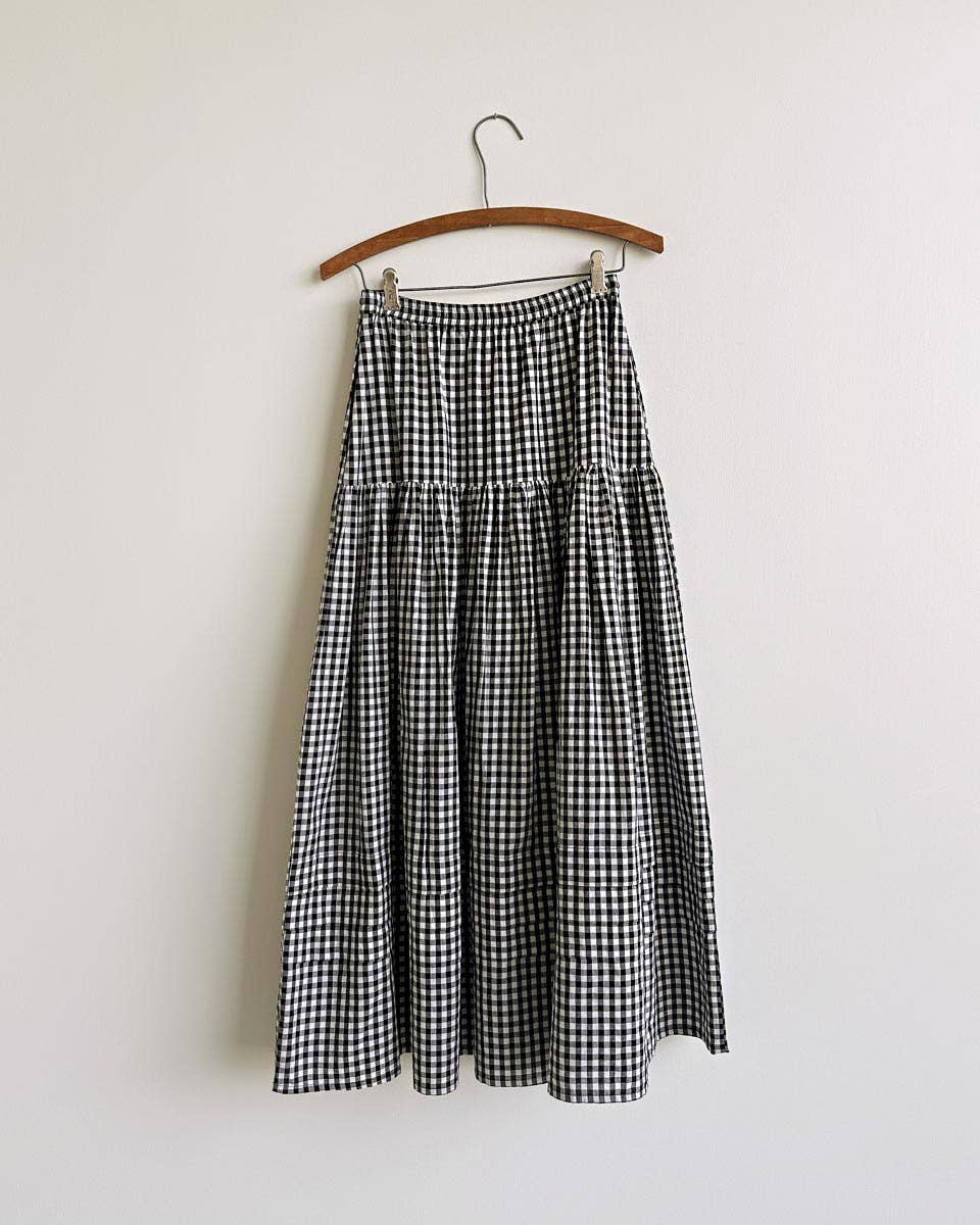 The Gardenne Gingham Midi Skirt a black and white gingham checkered skirt with a tiered seam and a waist tie at boltranchstore.com