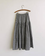 The Gardenne Gingham Midi Skirt a black and white gingham checkered skirt with a tiered seam and a waist tie at boltranchstore.com