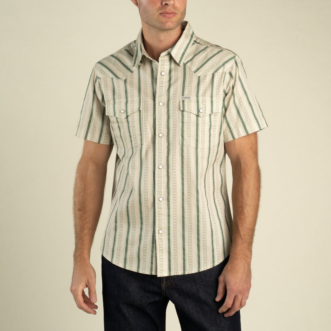 The Wyatt Pearl Snap Print Shirt at boltranchstore.com in stock free shipping A man wearing a short-sleeve western-style button-up shirt with vertical green and beige stripes, 