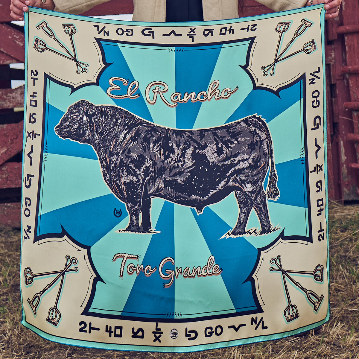 Fringe Scarves Toro Grande Angus Silk Scarf black Angus bull with branding iron motifs on blue sunburst rays womens western boutique Utah SKU SCRFTRGDSH26060