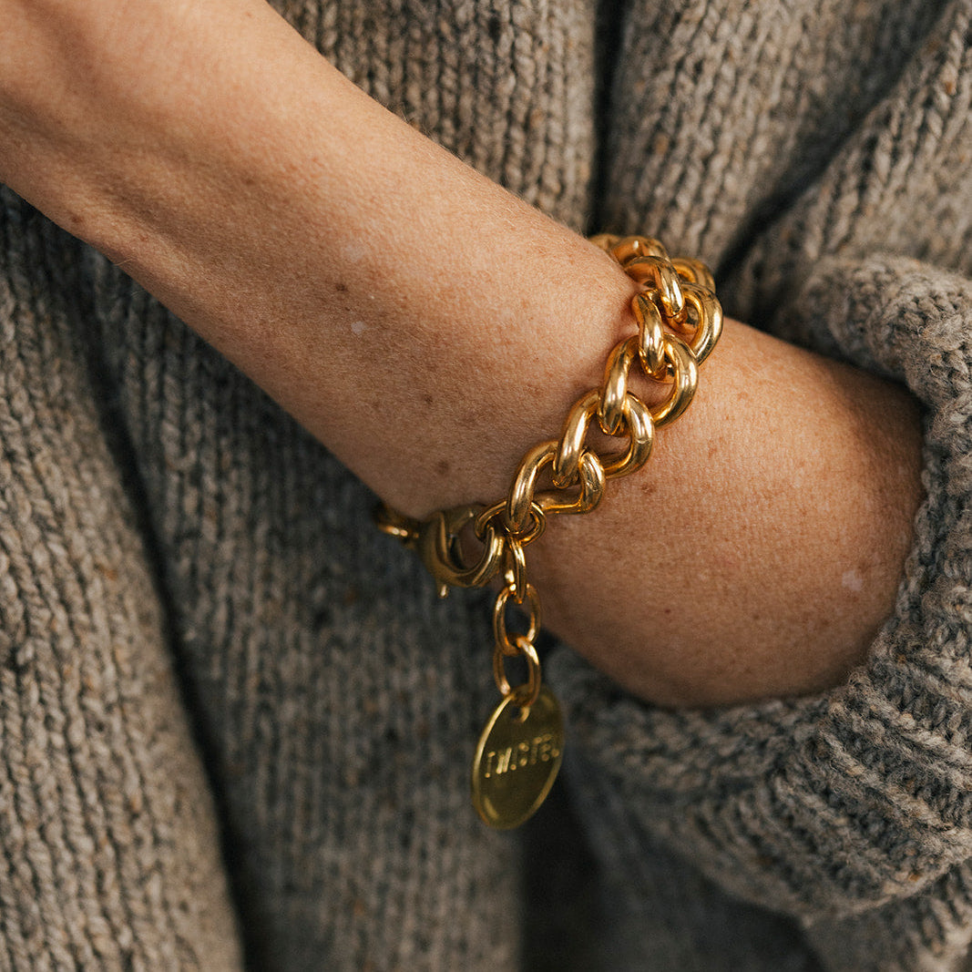 Twisted Silver Bond Bracelet at boltranchstore.com person's wrist wearing a chunky gold chain bracelet with a small round gold tag charm in stock free shipping womens 
