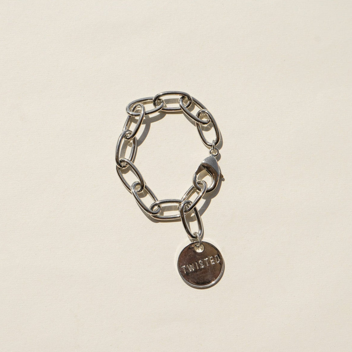 Twisted Silver Classic Bracelet at boltranchstore.com free shipping in stock A silver chain bracelet with a small round metal charm engraved with the word 'TWISTED', 