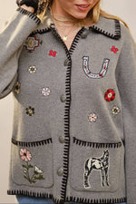 Long sleeve cardigan with contrast whipstitch trim, button front closure, patch pockets, and mixed embroidered motifs throughout for a playful, vintage-inspired look by Blue B sold near me Bolt Ranch Store Kamas Park City Utah