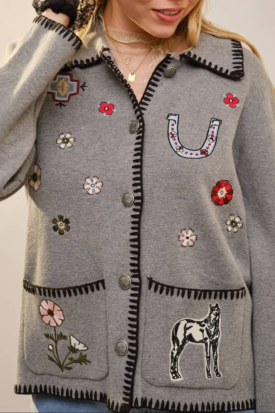 Long sleeve cardigan with contrast whipstitch trim, button front closure, patch pockets, and mixed embroidered motifs throughout for a playful, vintage-inspired look by Blue B sold near me Bolt Ranch Store Kamas Park City Utah