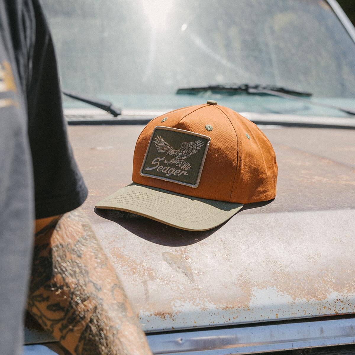 Seager Wingspan Snapback Maroon Green two tone cap worn with western fashion cowboy