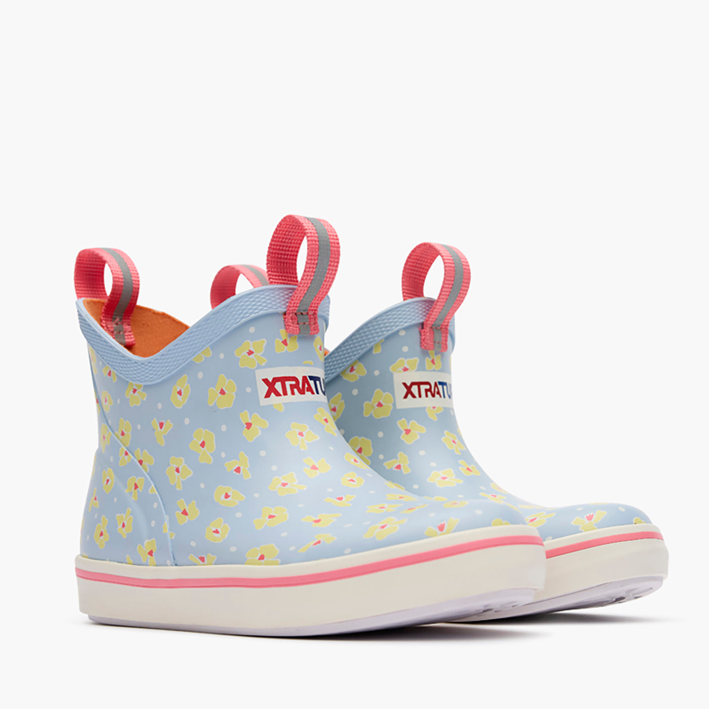 XTRATUF Kids Ankle Deck Boot at boltranchstore.com in A pair of rain boots in light blue with a yellow and pink floral pattern, featuring pink pull tabs and white soles in stock free shipping 