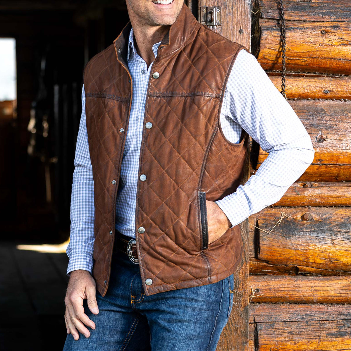 Madison Creek Outfitters Beaver Creek Waxed Goat Suede Leather Vest Bourbon snap front vest layered over a button down shirt for cowboy style in Park City