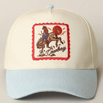 Cap with embroidered design of a cowboy on a horse, light blue brim and beige crown.denim brim boltranchstore.com