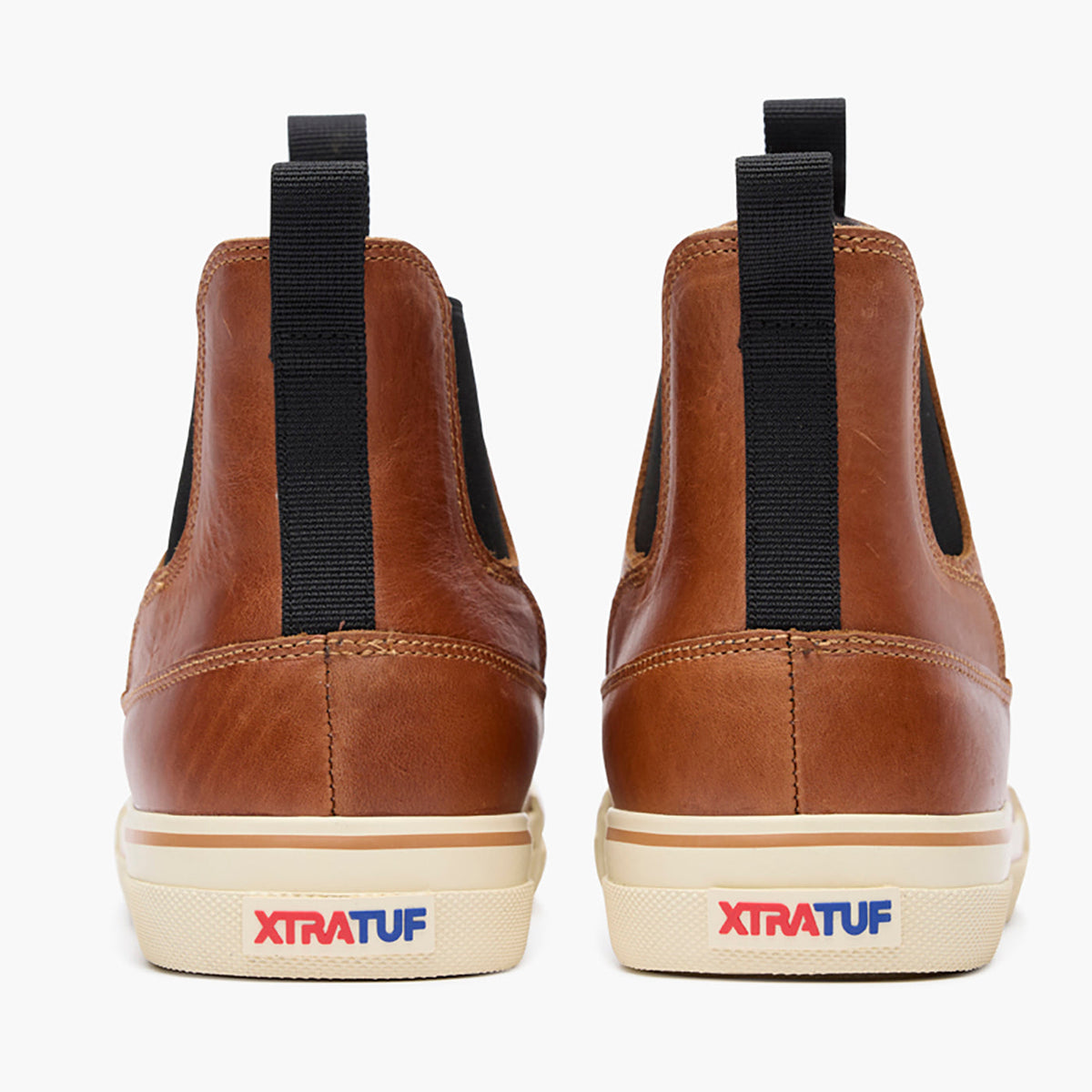 XTRATUF Mens Leather Chelsea Ankle Deck Boot Cashew front and rear pull on tabs with red and blue logo heel on a cream rubber sole cowboy
